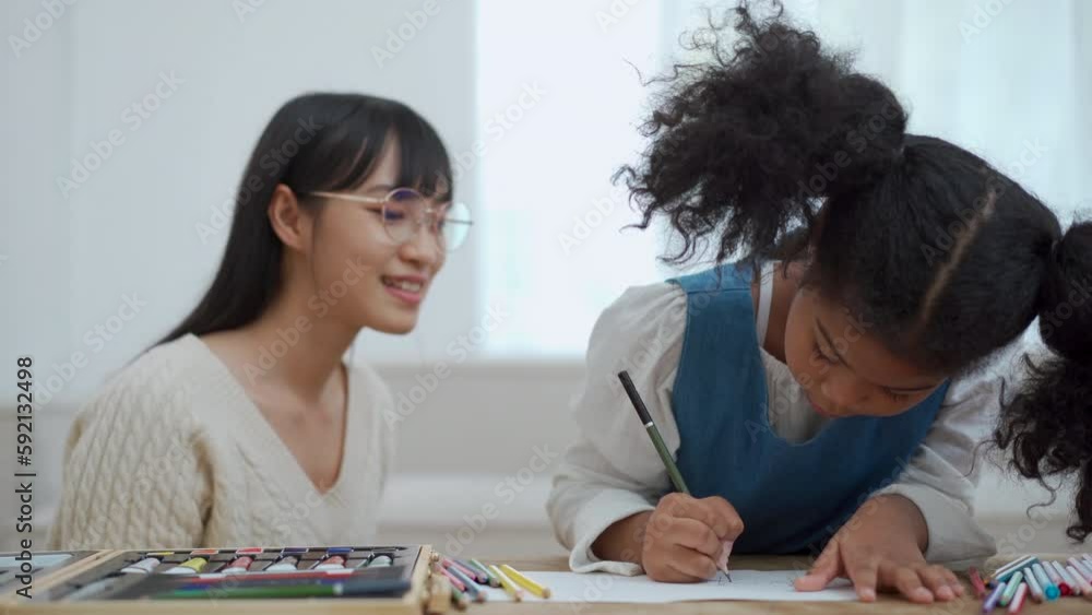 Little girl enjoy drawing and painting with her sister. Little girl enjoy drawing and painting with her sister.