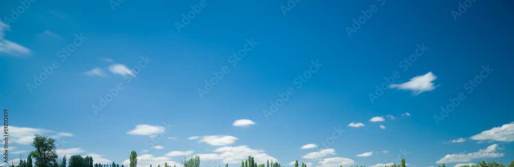 Long exposure photo of white clouds in blue sky