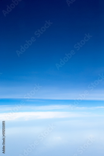 white fluffy clouds with rainbow in the blue sky