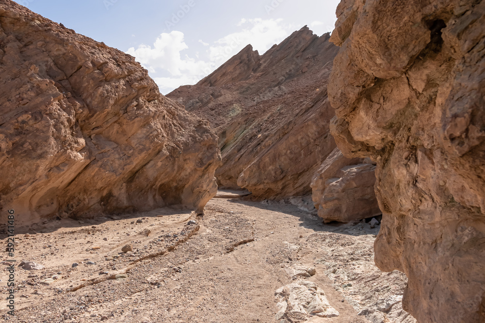 Obraz premium Golden Canyon trailhead with scenic view of colorful geology of multi hued Amargosa Chaos rock formations, Death Valley National Park, Furnace Creek, California, USA. Barren Artist Palette landscape
