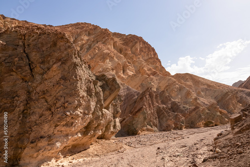 Golden Canyon trailhead with scenic view of colorful geology of multi hued Amargosa Chaos rock formations  Death Valley National Park  Furnace Creek  California  USA. Barren Artist Palette landscape
