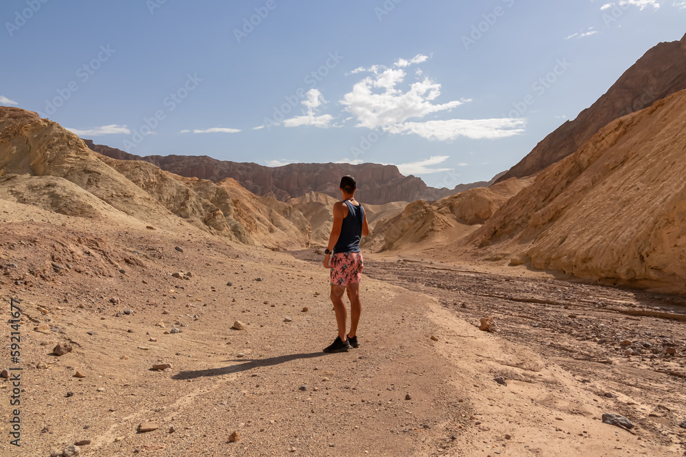 Fototapeta premium Golden Canyon trailhead with scenic view of colorful geology of multi hued Amargosa Chaos rock formations, Death Valley National Park, Furnace Creek, California, USA. Barren Artist Palette landscape