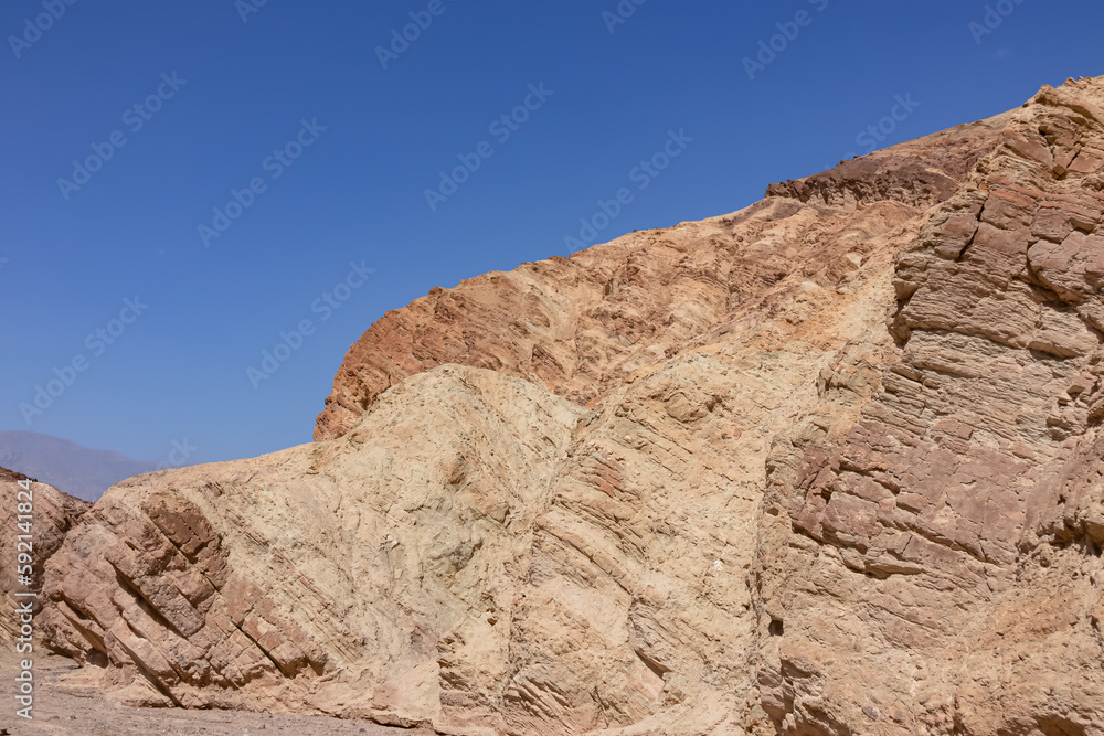 Golden Canyon trailhead with scenic view of colorful geology of multi hued Amargosa Chaos rock formations, Death Valley National Park, Furnace Creek, California, USA. Barren Artist Palette landscape