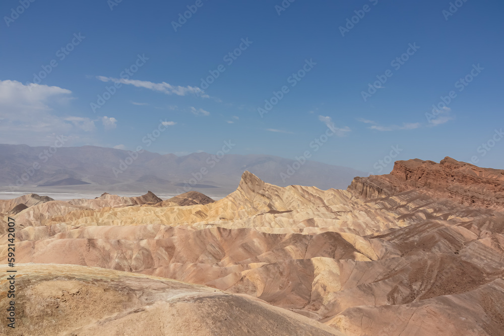 Scenic view of summit peak Manly Beacon seen from Zabriskie Point, Badlands, Furnace creek, Death Valley National Park, California, USA. Erosional landscape of multi hued Amargosa Chaos rock formation Scenic view of summit peak Manly Beacon seen from Zabriskie Point, Badlands, Furnace creek, Death Valley National Park, California, USA. Erosional landscape of multi hued Amargosa Chaos rock formation