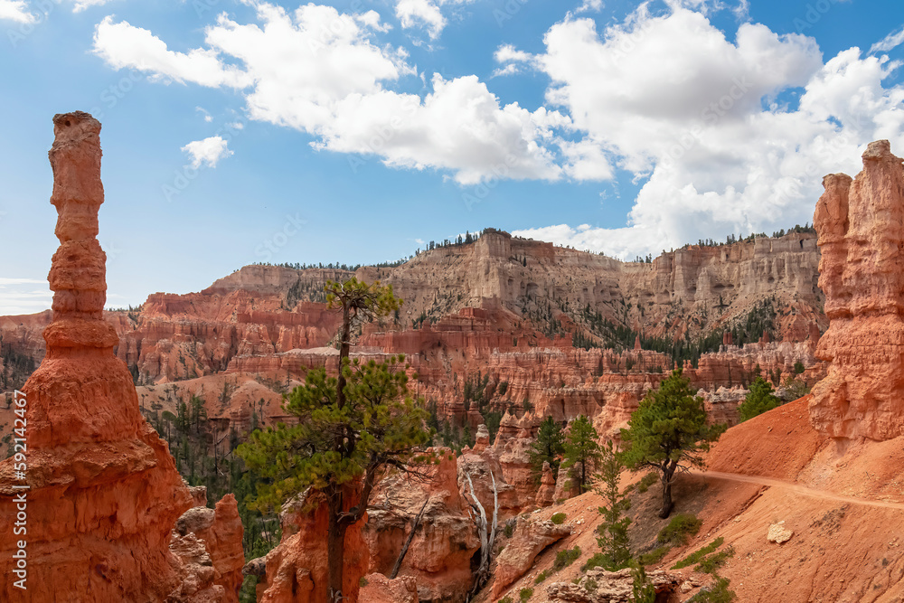 Scenic view of massive steep hoodoo sandstone rock formation with blue background on Peekaboo hiking trail in Bryce Canyon National Park, Utah, USA. Barren desert landscape in natural amphitheatre