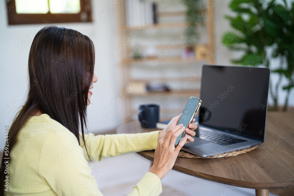 Business woman working from home. work online on laptop. Asian businesswoman working on sofa online business with social distancing laptop online meeting Business woman working from home. work online on laptop. Asian businesswoman working on sofa online business with social distancing laptop online meeting