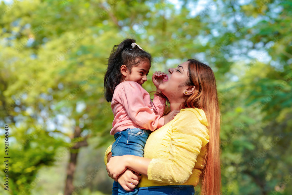 Indian woman with her little daughter at park Indian woman with her little daughter at park