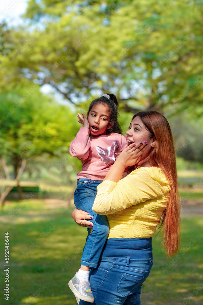 Indian woman with her little daughter at park Indian woman with her little daughter at park
