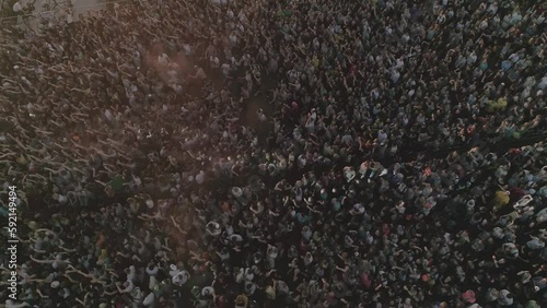 Crowd of people at a concert in the evening, View from drone