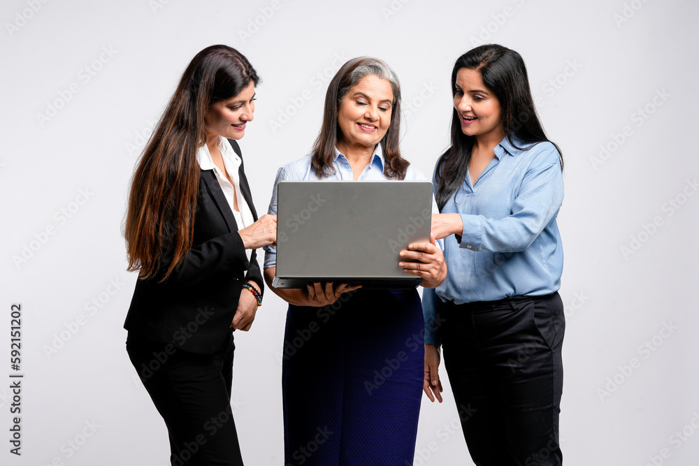 senior female executive showing detail in laptop to his two young colleague. senior female executive showing detail in laptop to his two young colleague.