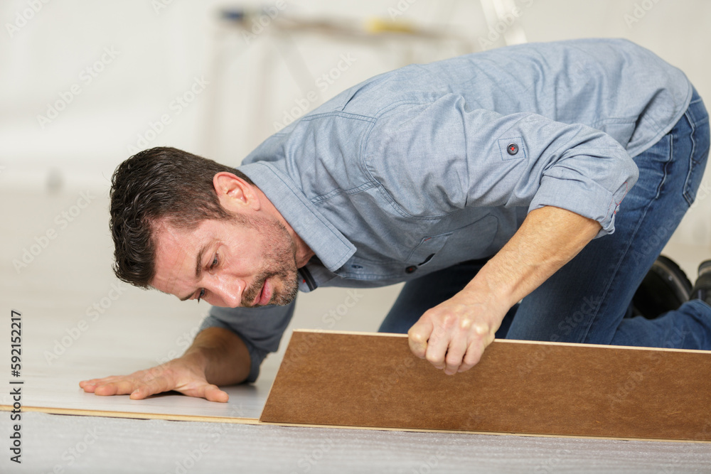 a man during flooring installation a man during flooring installation