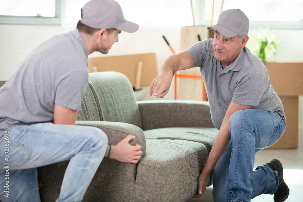 two contractor employees moving personal belongings