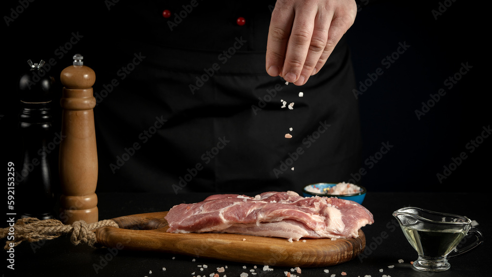 a man adds spices to meat