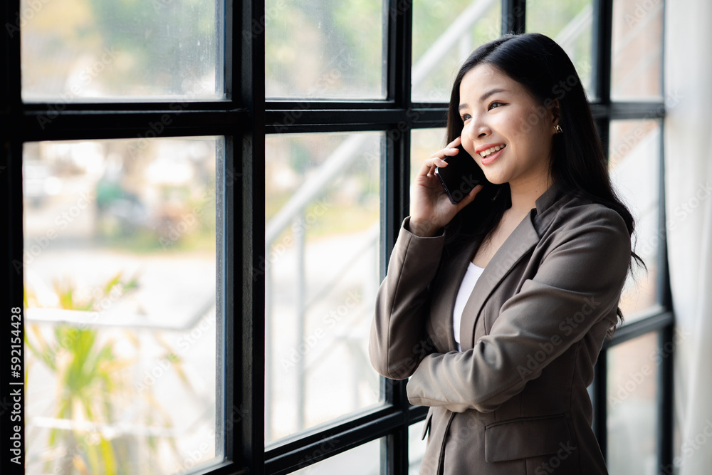 Business woman talking on the phone, young Asian women as executives, founding and running start-up executives, young female business leaders. Startup business concept. Business woman talking on the phone, young Asian women as executives, founding and running start-up executives, young female business leaders. Startup business concept.