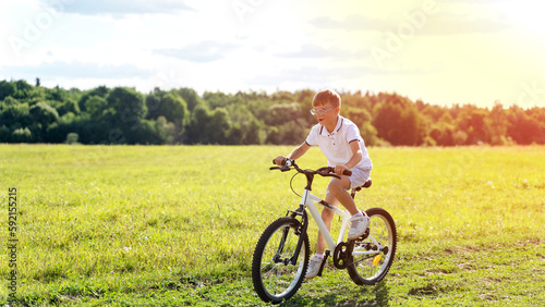a boy rides a bike in the park