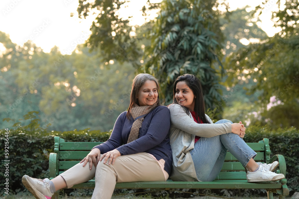 Two indian woman sitting at park in winter wear. Two indian woman sitting at park in winter wear.