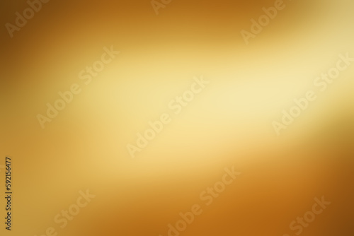 Light shining down on gold foil metal with copy space, abstract background.