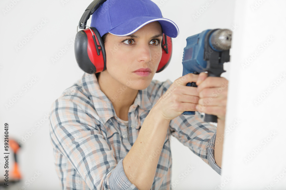 woman construction worker working with screwdriver woman construction worker working with screwdriver