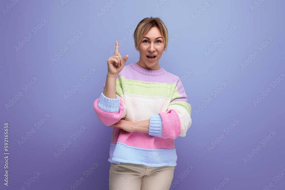 portrait of genius smiling blond young woman in casual outfit with idea on purple background with copy space portrait of genius smiling blond young woman in casual outfit with idea on purple background with copy space