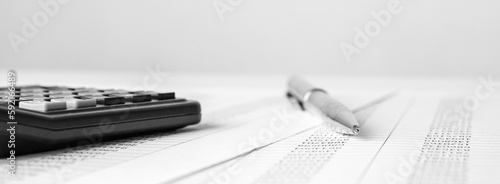 Calculator on financial statement and balance sheeet on desk of auditor. Concept of accounting and audit business.