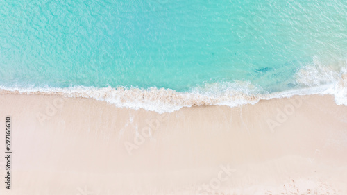 Aerial top view on nature landscape view of beautiful tropical clean sandy beach and soft blue ocean. Aerial top-down drone view.