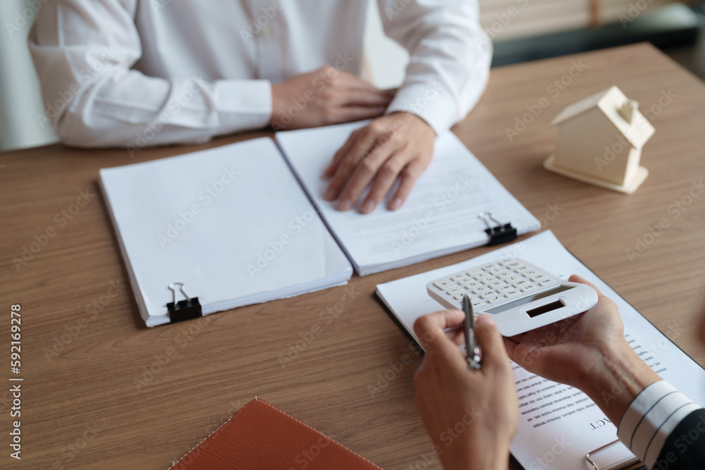Property investment concept. Real estate broker with home insurance policy about house contract.. Property investment concept. Real estate broker with home insurance policy about house contract..