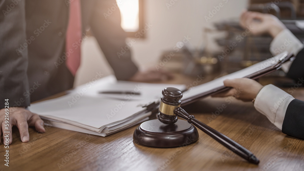 Justice lawyer considering a legal documents in courtroom.. Justice lawyer considering a legal documents in courtroom..