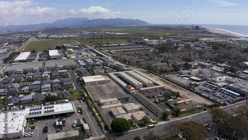 High panning aerial shot of an industrial park in Port Hueneme with the Santa Monica Mountains in the background. 4K photo