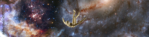  wooden mannequin falling in space against the background of a starry space landscape