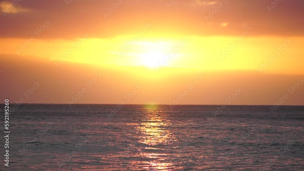 Blurred golden sea at sunset. The sun reflects and sparkles on the waves with bokeh, illuminating the golden sea. Holiday recreation concept. Abstract nautical summer ocean sunset nature background. Blurred golden sea at sunset. The sun reflects and sparkles on the waves with bokeh, illuminating the golden sea. Holiday recreation concept. Abstract nautical summer ocean sunset nature background.