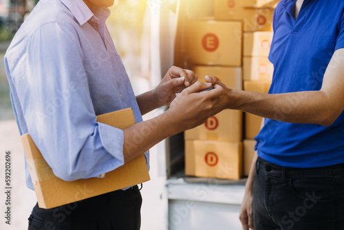 Startup small business entrepreneur or freelance Asian woman using a laptop with box, Young success Asian woman with her hand lift up, online marketing packaging box and delivery, SME concept.