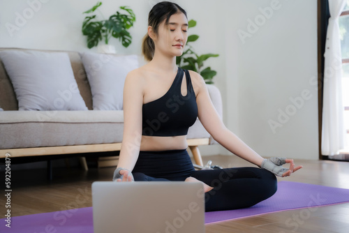 Young woman asian practicing breathing exercise.