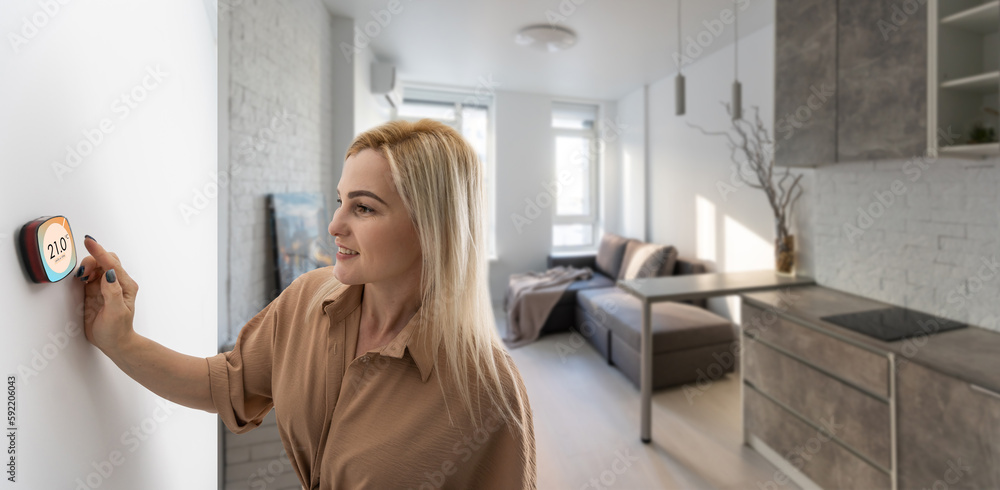 Woman using smartphone monitor to control home connectivity interface Woman using smartphone monitor to control home connectivity interface