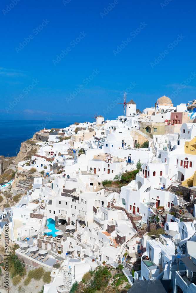 Oia, traditional view with windmills, white greek village of Santorini, Greece