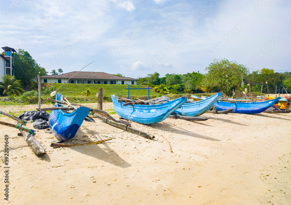 Beautiful tropical landscape with colorful fishing village boats. Photography for tourism background, design and advertising. 10 January 2023, Sooriya, Sri Lanka Beautiful tropical landscape with colorful fishing village boats. Photography for tourism background, design and advertising. 10 January 2023, Sooriya, Sri Lanka