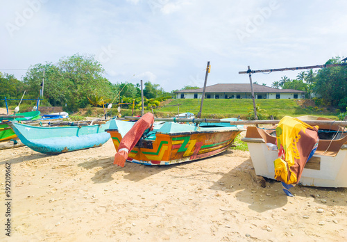 Fototapeta Naklejka Na Ścianę i Meble -  Beautiful tropical landscape with colorful fishing village boats.  Photography for tourism background, design and advertising. 10 January 2023, Sooriya, Sri Lanka