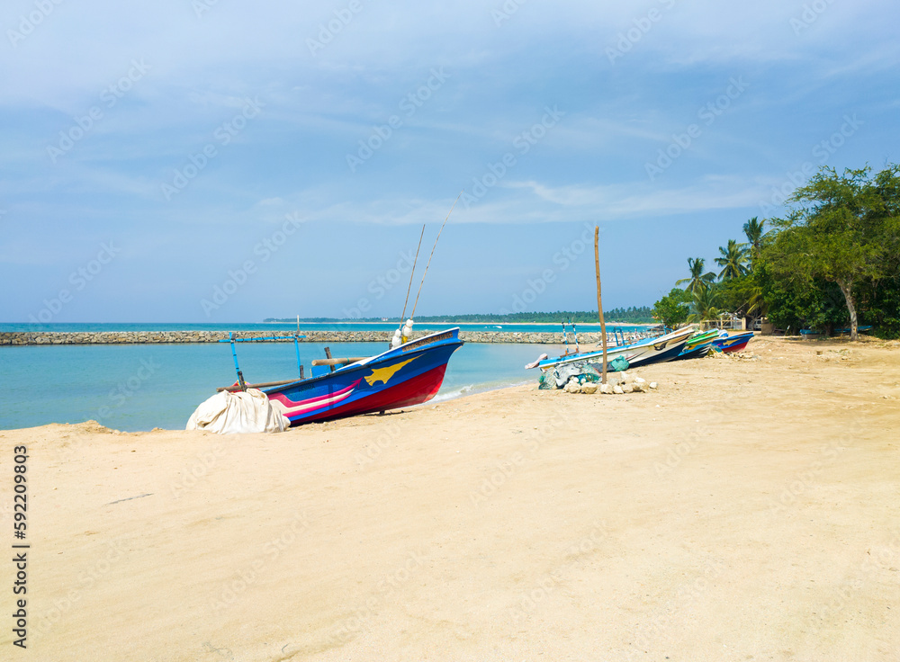 Beautiful tropical landscape with colorful fishing village boats. Photography for tourism background, design and advertising. 10 January 2023, Sooriya, Sri Lanka Beautiful tropical landscape with colorful fishing village boats. Photography for tourism background, design and advertising. 10 January 2023, Sooriya, Sri Lanka