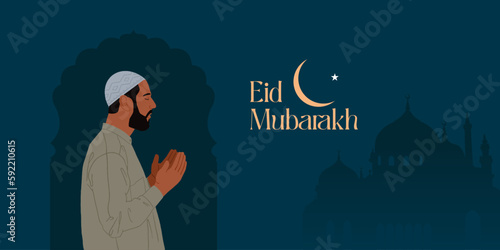 Religious Muslim young man praying in front of mosque on night background for holy month of Muslim community Ramadan Kareem.