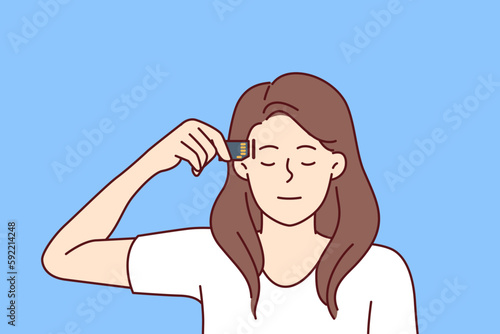 Woman robot closing eyes applies memory card to head, symbolizing modern technologies for integrating chips into human brain. Girl robot with artificial intelligence takes out microprocessor 