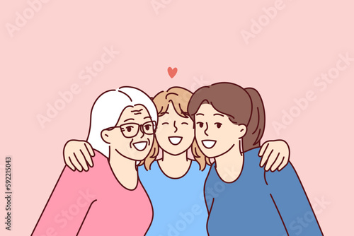 Family portrait of three female generations with teenage girl lovingly hugging mother and grandmother. Happy women of different generations spend time together enjoying family vacation