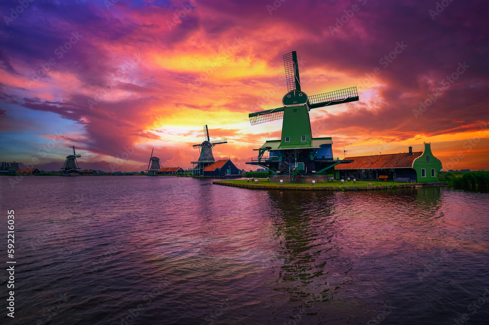 Dramatic sunset above farm houses and windmills of Zaanse Schans, Netherlands Dramatic sunset above farm houses and windmills of Zaanse Schans, Netherlands