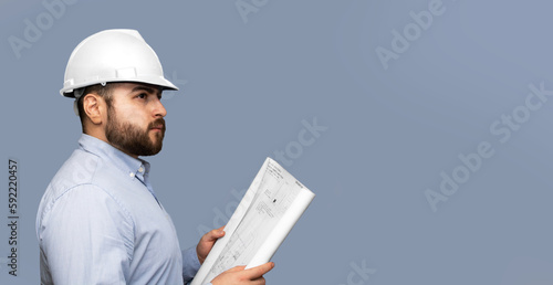 Foto hombre de la construcción  de casco blanco con un plano en sus manos con espacio