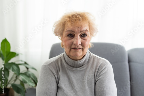 Positive confident pretty mature business leader woman head shot portrait. Senior black short haired lady looking at camera, smiling, posing in office indoors. Banner shot.