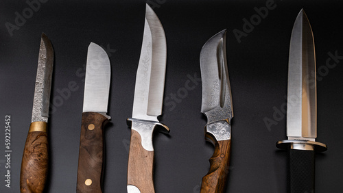 Damascus steel knives on a black background. Kitchen knives. background with japanese knife. A set of Japanese Damascus steel knives. Banner