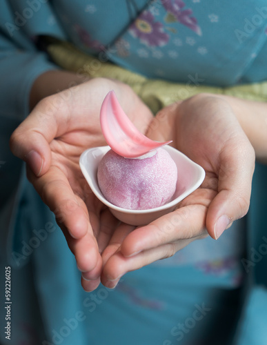 Fotografie Japanese confectionery Daifuku, small round glutinous rice dessert, on hands