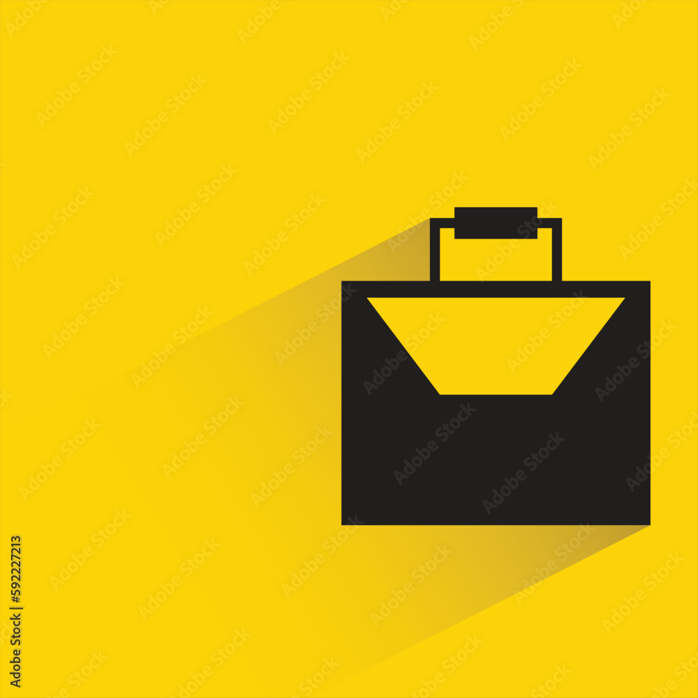 briefcase with shadow on yellow background briefcase with shadow on yellow background