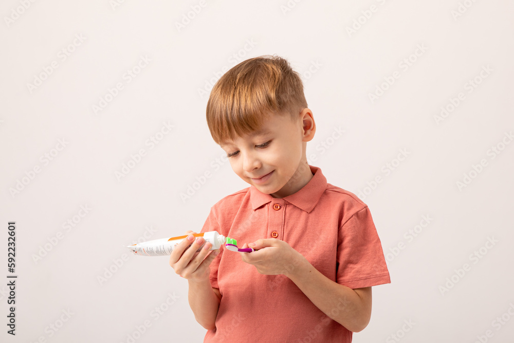 Happy child kid boy brushing teeth with toothbrush on white background. Health care, dental hygiene. Mockup, copy space Happy child kid boy brushing teeth with toothbrush on white background. Health care, dental hygiene. Mockup, copy space