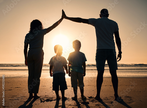 Family, sunset and outdoor silhouette at beach with children and parents together at sea for security. Man, woman and kids from back on holiday or vacation at ocean with love, care and support
