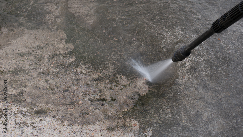 high pressure cleaner in operation. jet spray. coupling of the water pipe. industrial jobs. high pressure cleaner in operation. jet spray. coupling of the water pipe. industrial jobs.