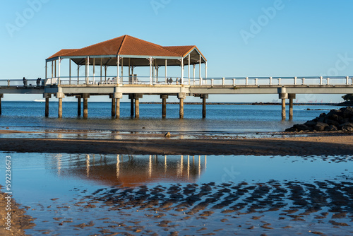 Redcliffe Jetty rotunda reflected in pool of water at low tide.  Port of Brisbane on the horizon. Redcliffe, Queensland, Australia  © Silky Oaks